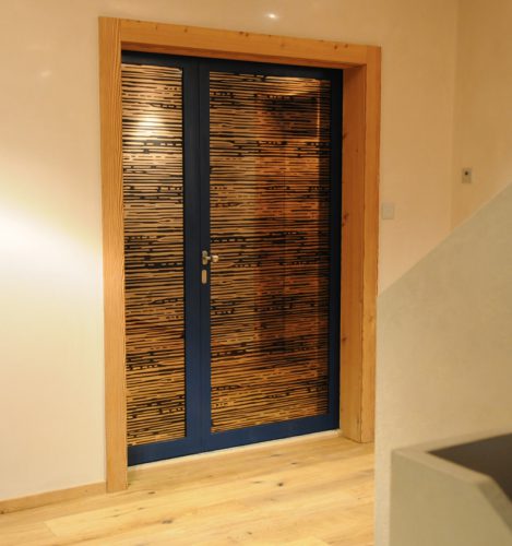 Glass door with dark blue wood