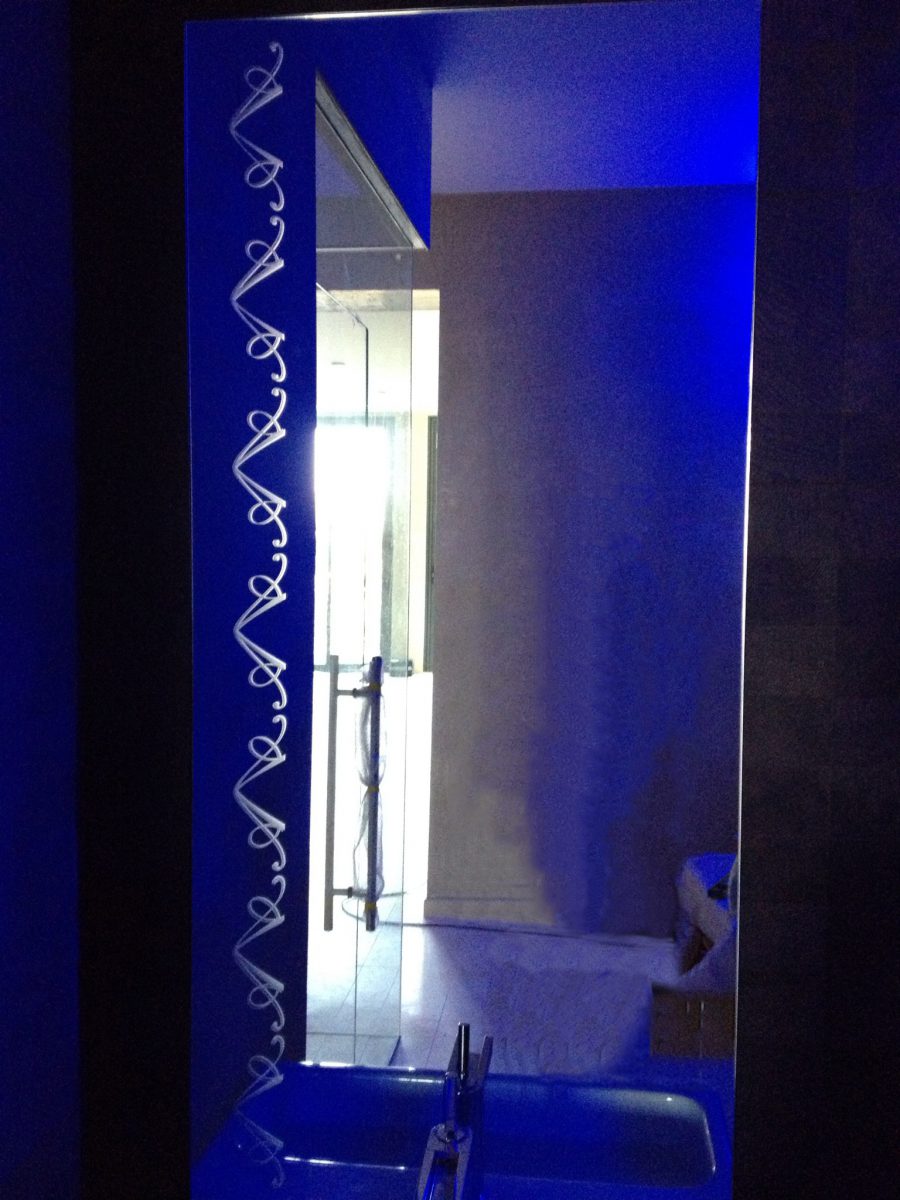 Sandblasted-bordered mirrors with etched logos installed in the basement games room, dance room, master bedroom, and guest bedrooms.