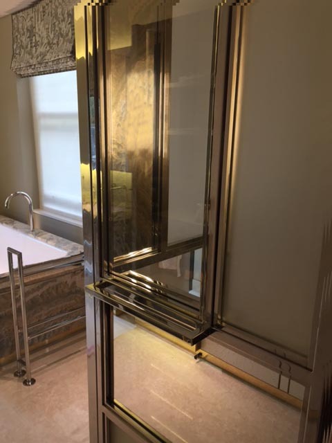 WC / shower room enclosure with various mirror finishes set in a polished chrome framework.